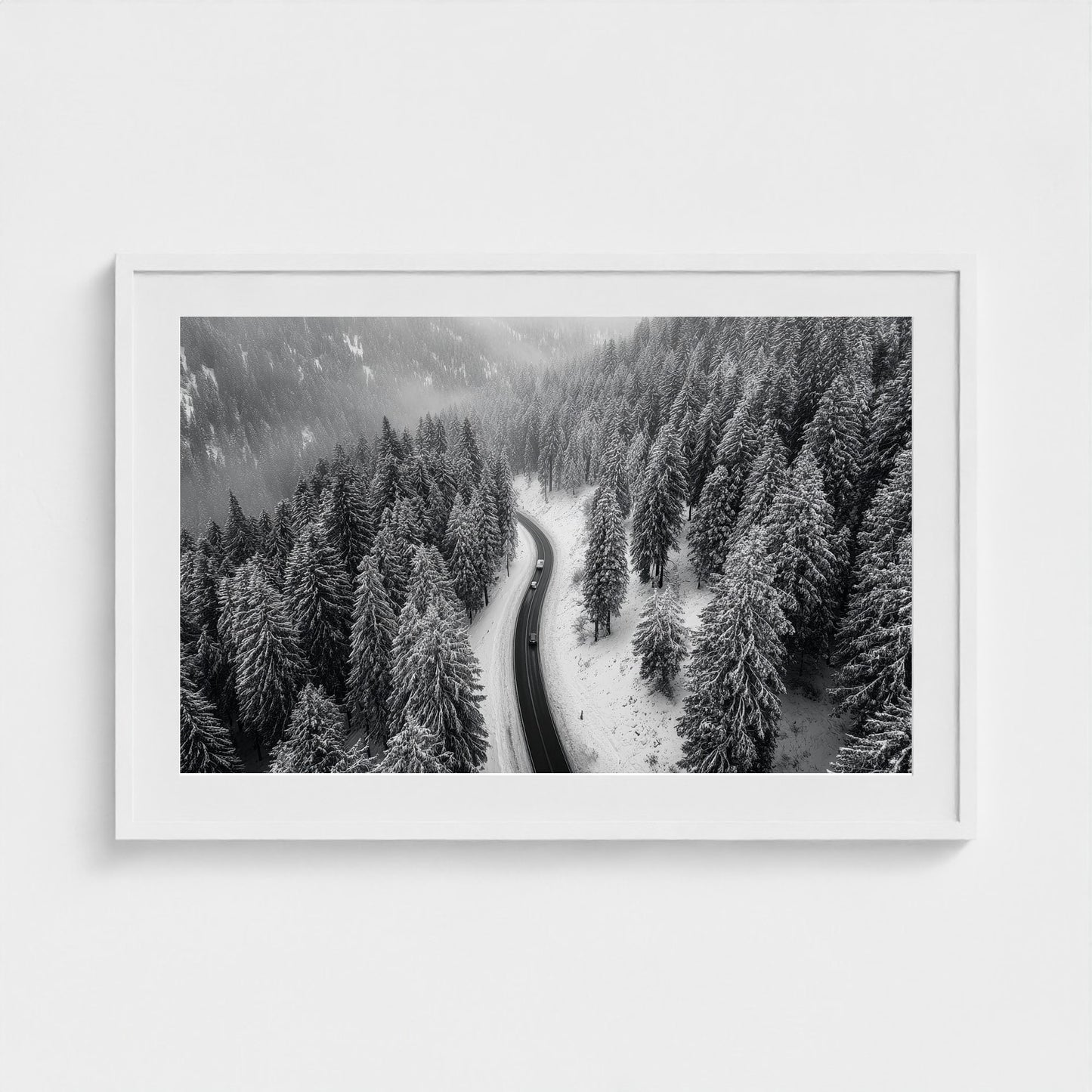 aerial-of-snow-covered-road-slicing-through-dark 36x24-white frame frame