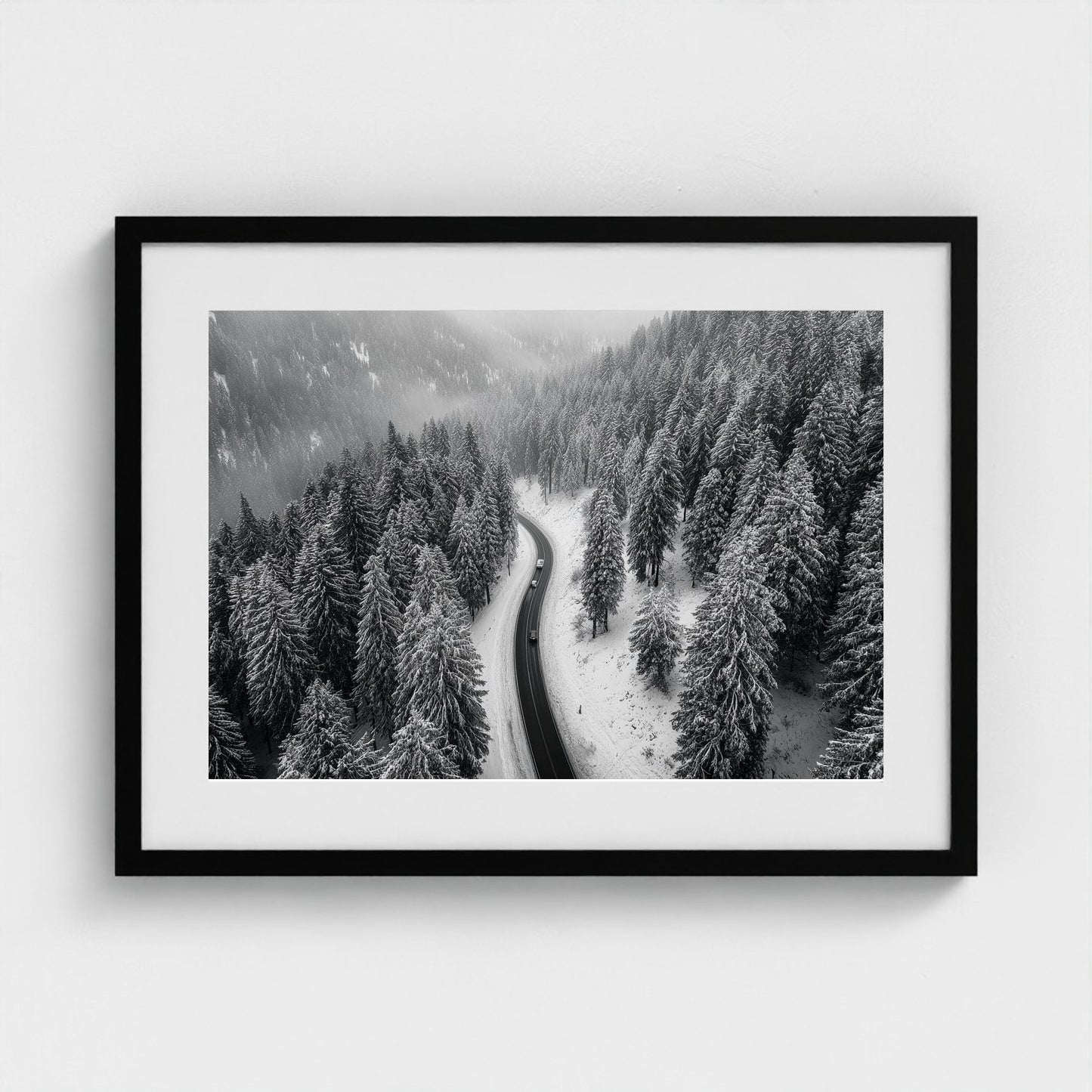 aerial-of-snow-covered-road-slicing-through-dark 24x18-black frame frame