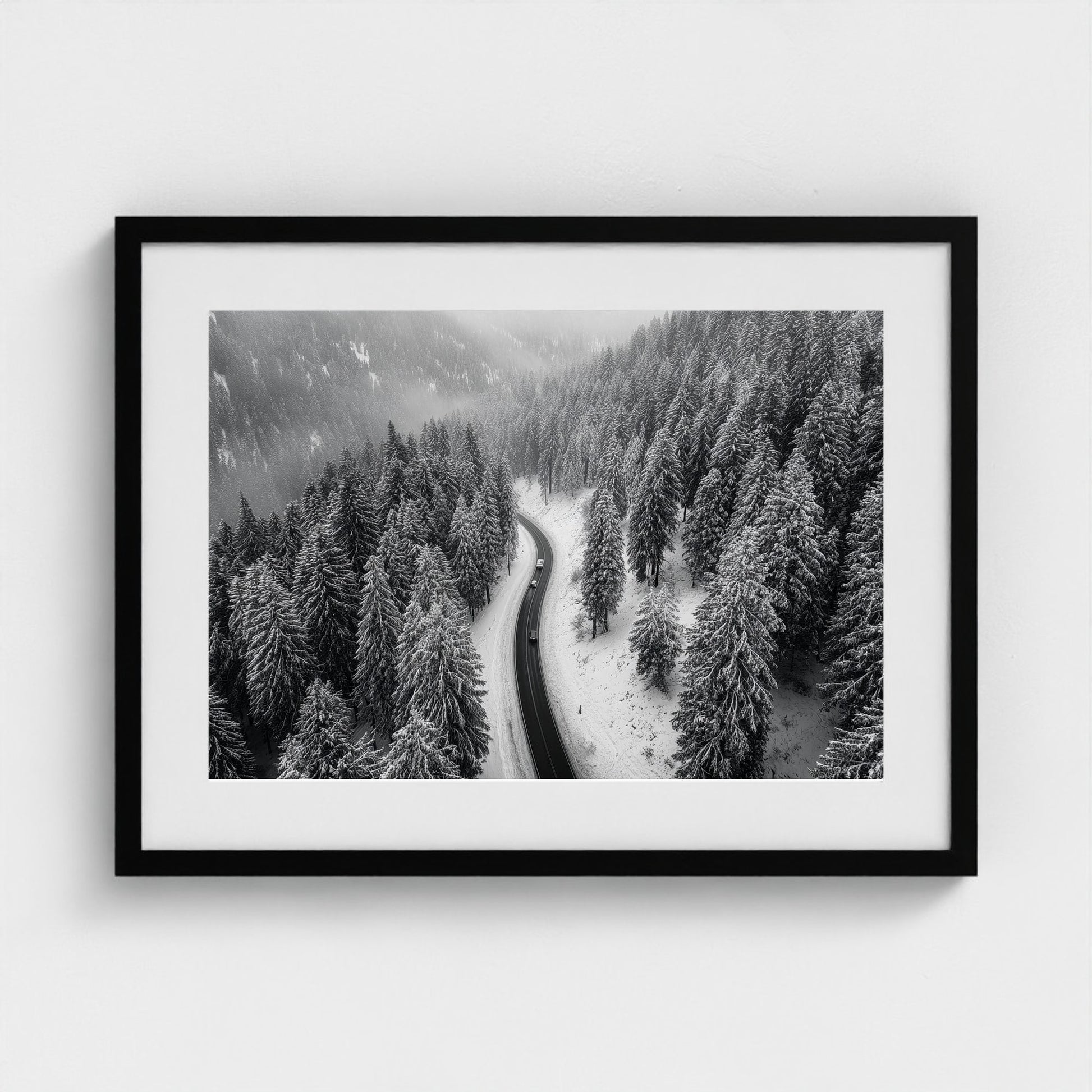 aerial-of-snow-covered-road-slicing-through-dark 24x18-black frame frame