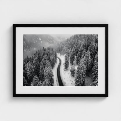 aerial-of-snow-covered-road-slicing-through-dark 24x18-black frame frame