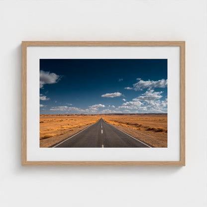 vast-open-desert-with-single-road-disappearing-i 24x18-natural frame frame