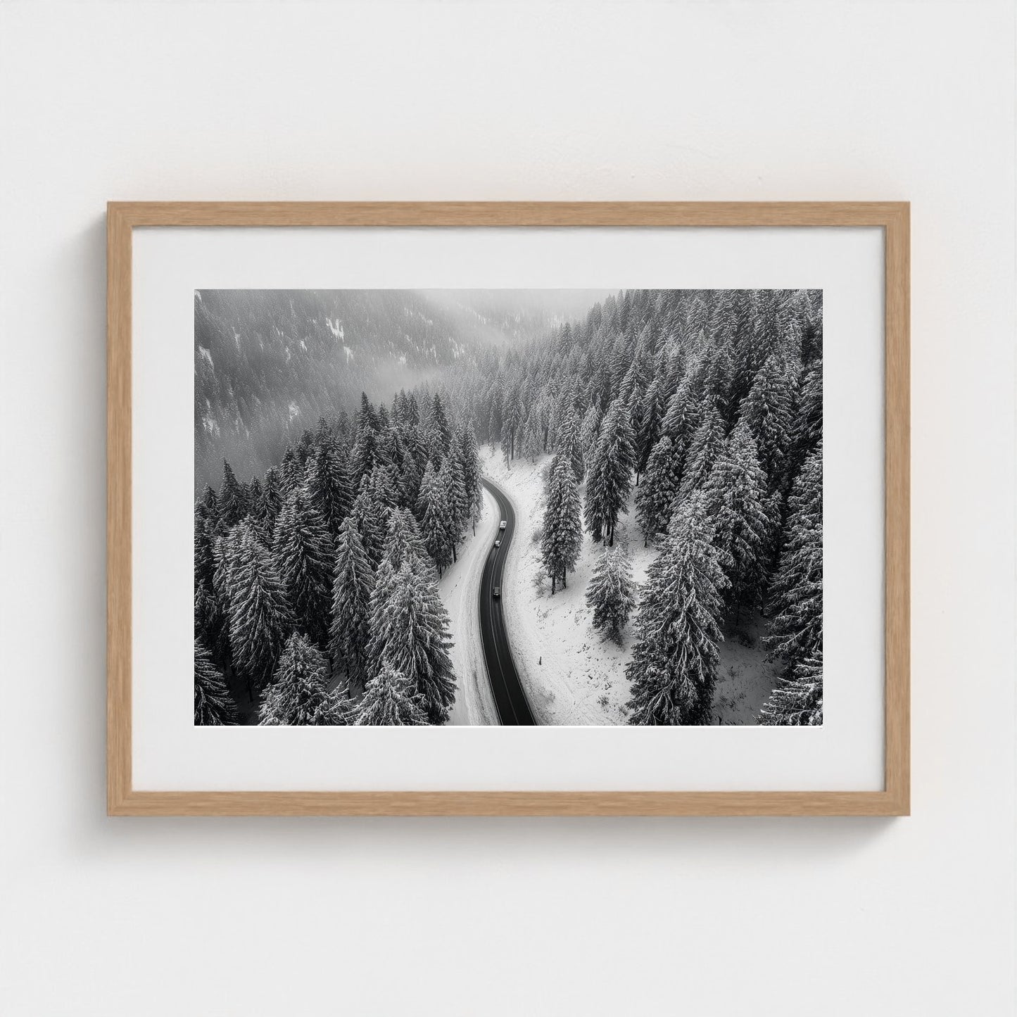 aerial-of-snow-covered-road-slicing-through-dark 24x18-natural frame frame