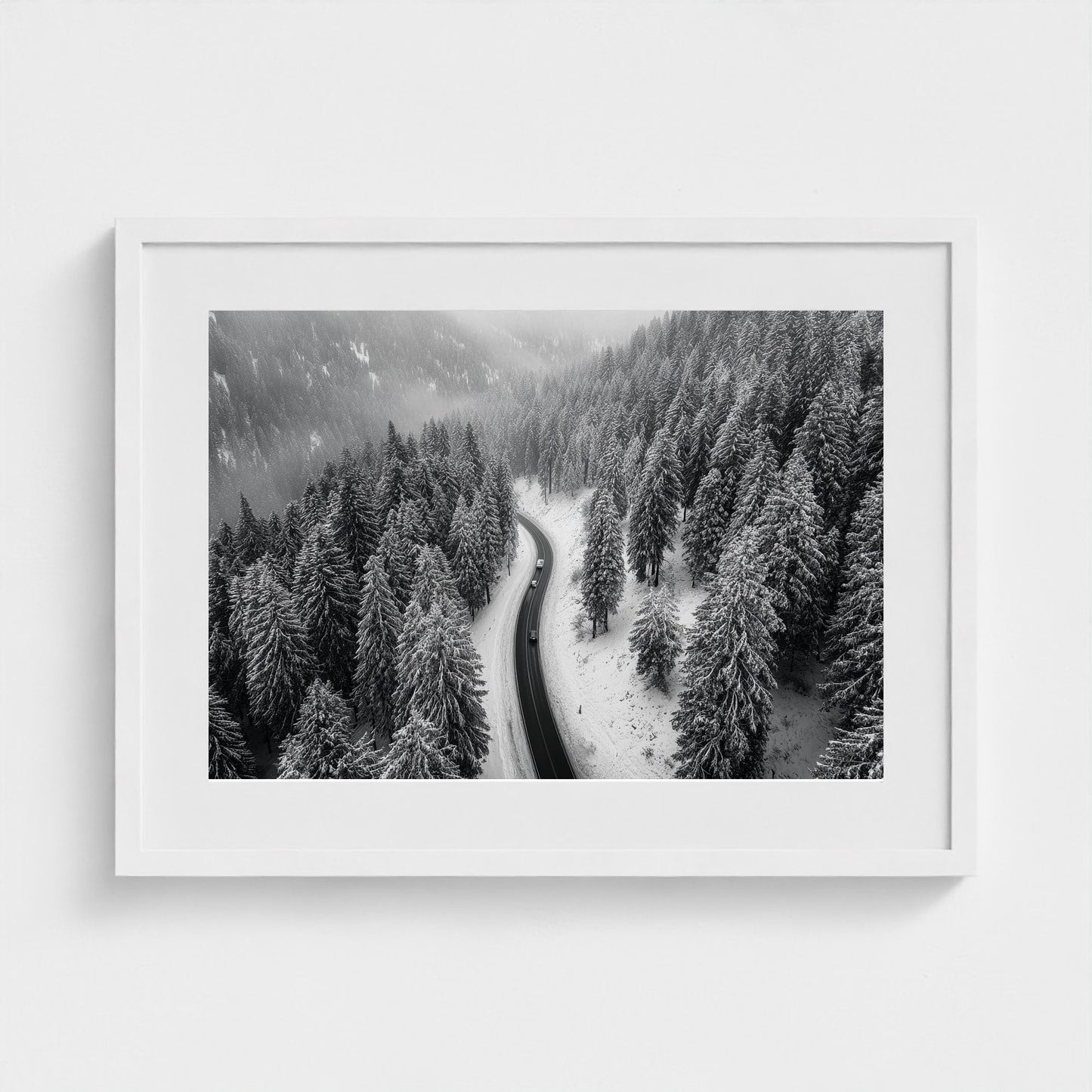 aerial-of-snow-covered-road-slicing-through-dark 24x18-white frame frame