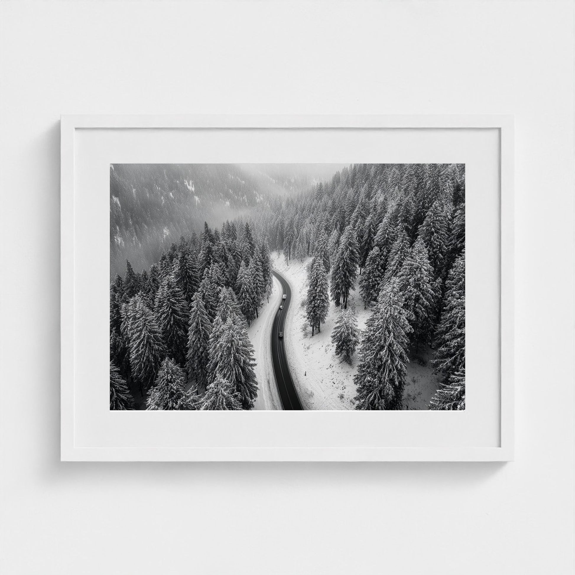 aerial-of-snow-covered-road-slicing-through-dark 24x18-white frame frame