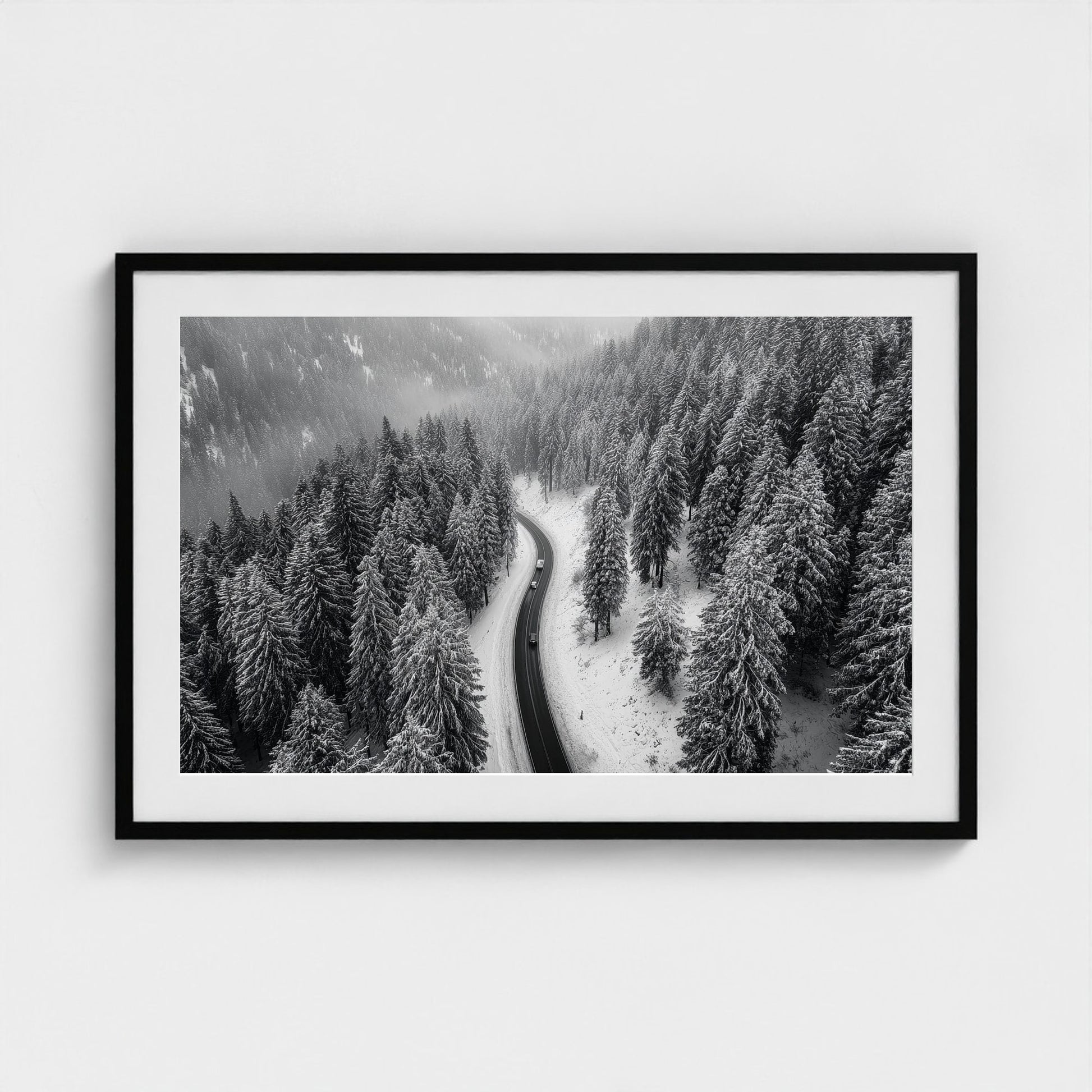 aerial-of-snow-covered-road-slicing-through-dark 36x24-black frame frame