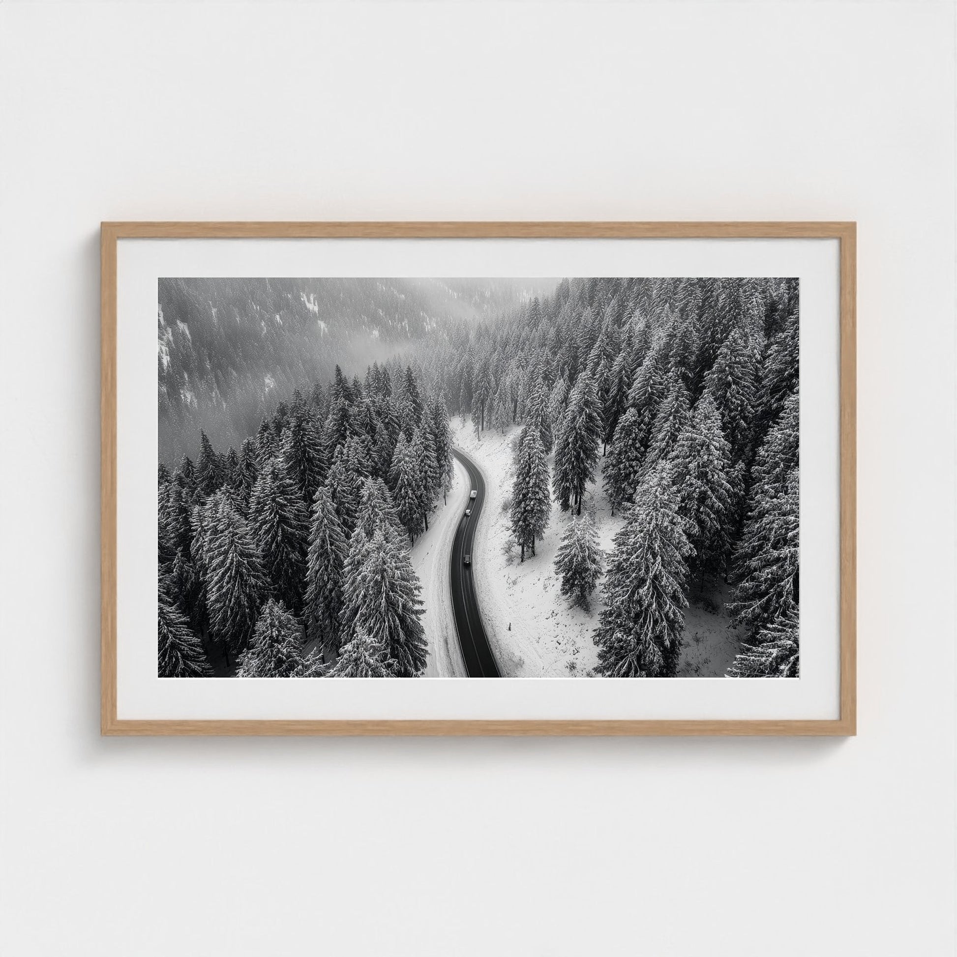 aerial-of-snow-covered-road-slicing-through-dark 36x24-natural frame frame