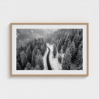 aerial-of-snow-covered-road-slicing-through-dark 36x24-natural frame frame
