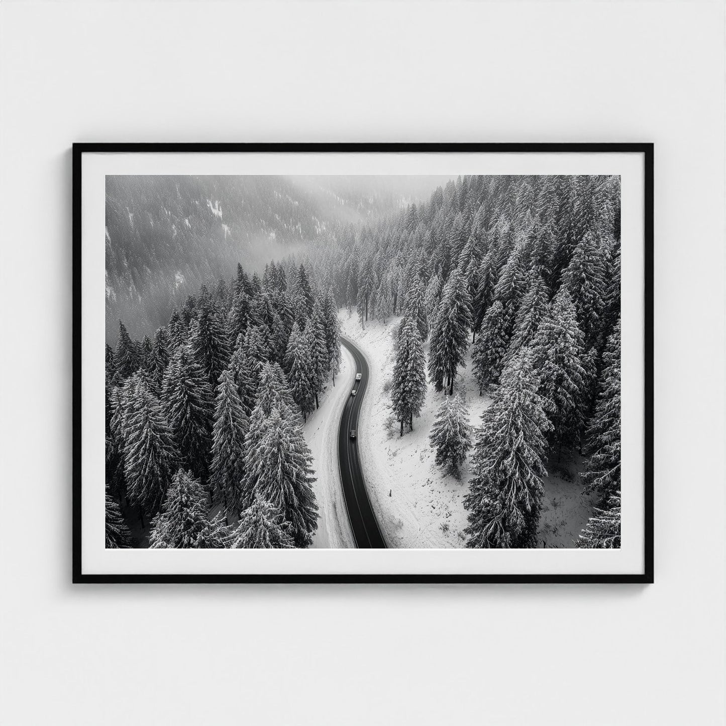 aerial-of-snow-covered-road-slicing-through-dark 48x36-black frame frame