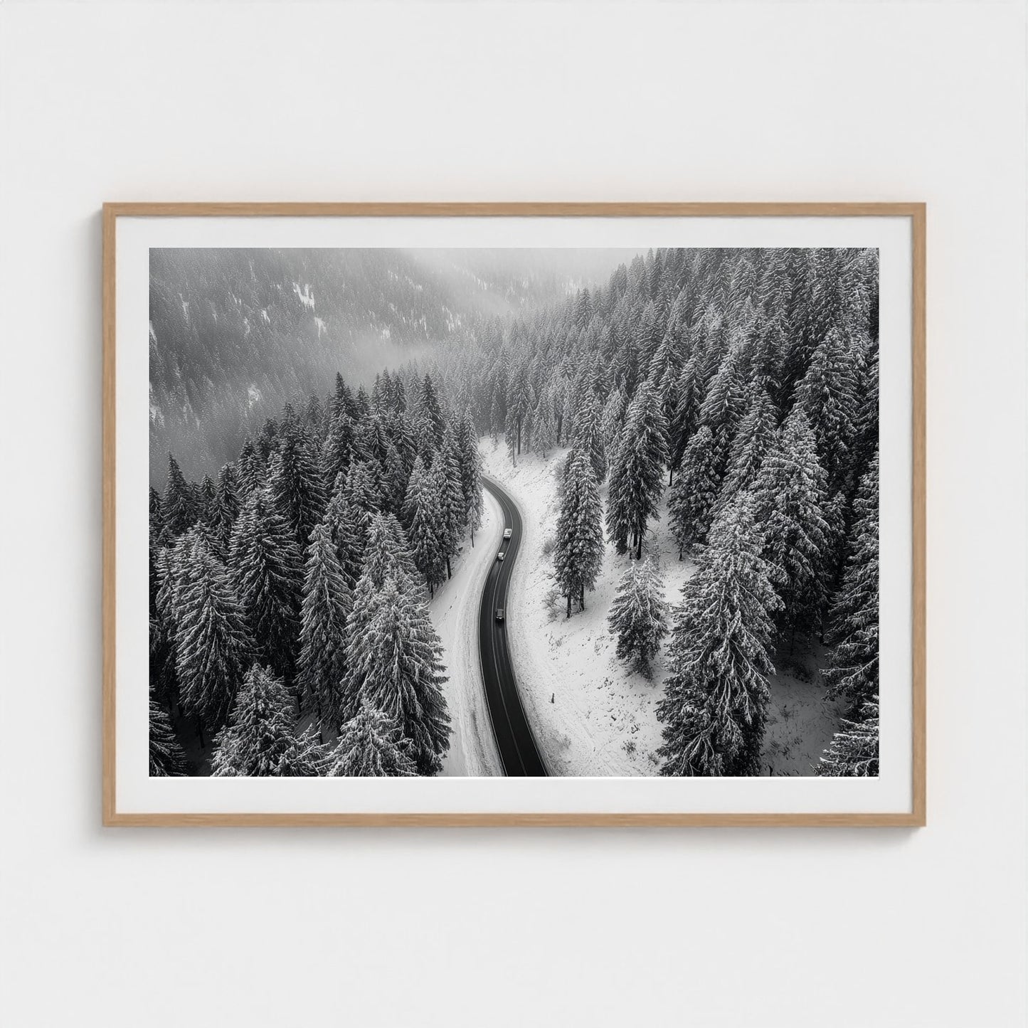 aerial-of-snow-covered-road-slicing-through-dark 48x36-natural frame frame